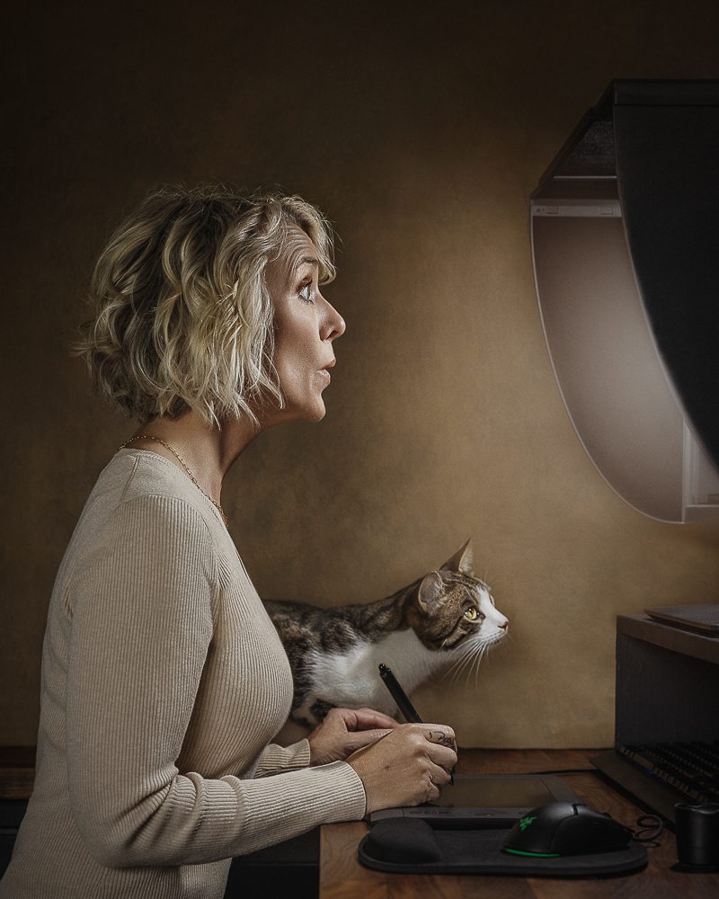 Photographer at editing desk with cat