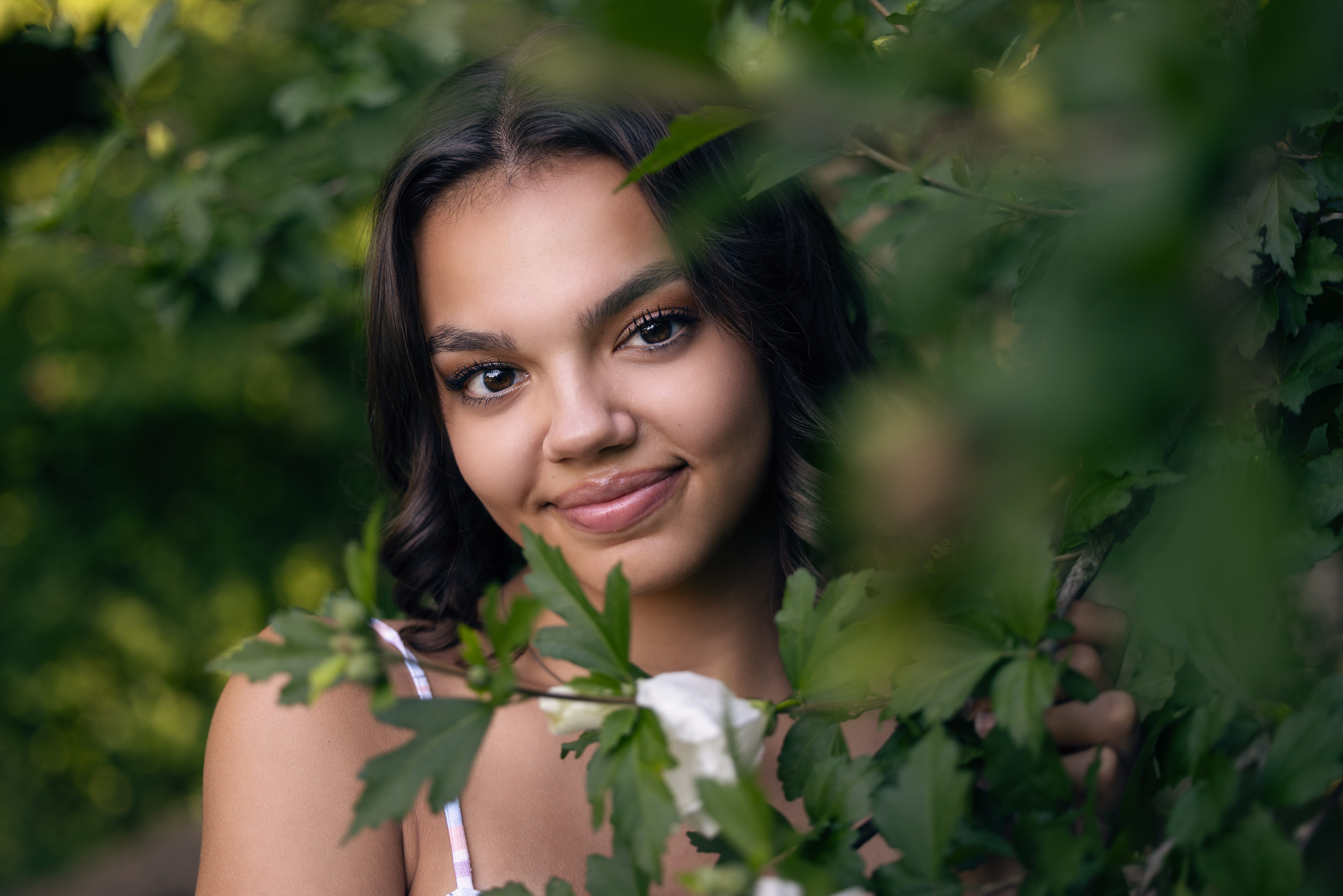 Teen girl among foliage