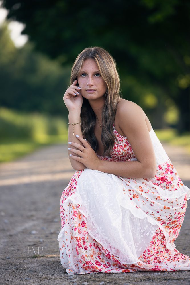High school senior girl in park wearing dress