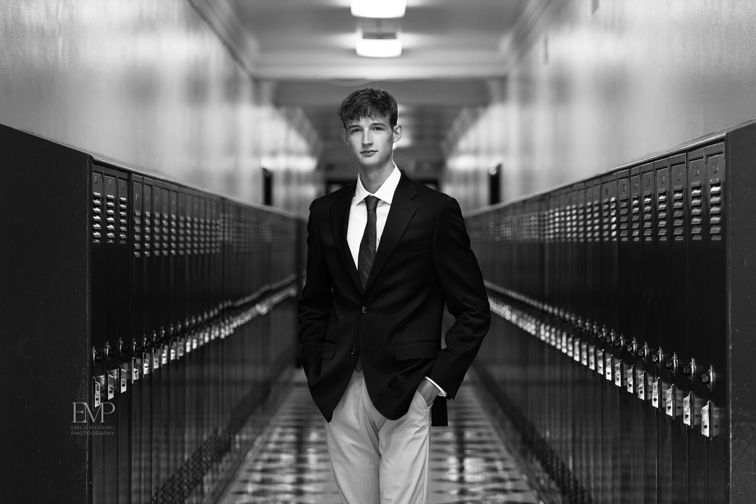 High school senior guy among lockers in school