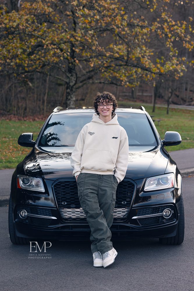 High school senior guy with his car