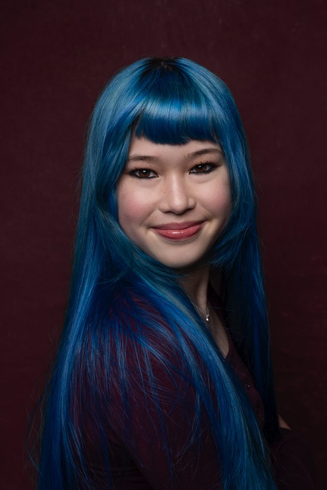 Teen with blue hair studio portrait