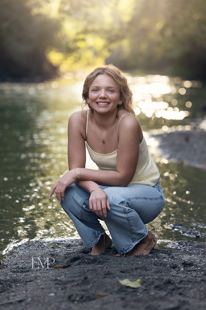 High School senior girl at creek in golden hour